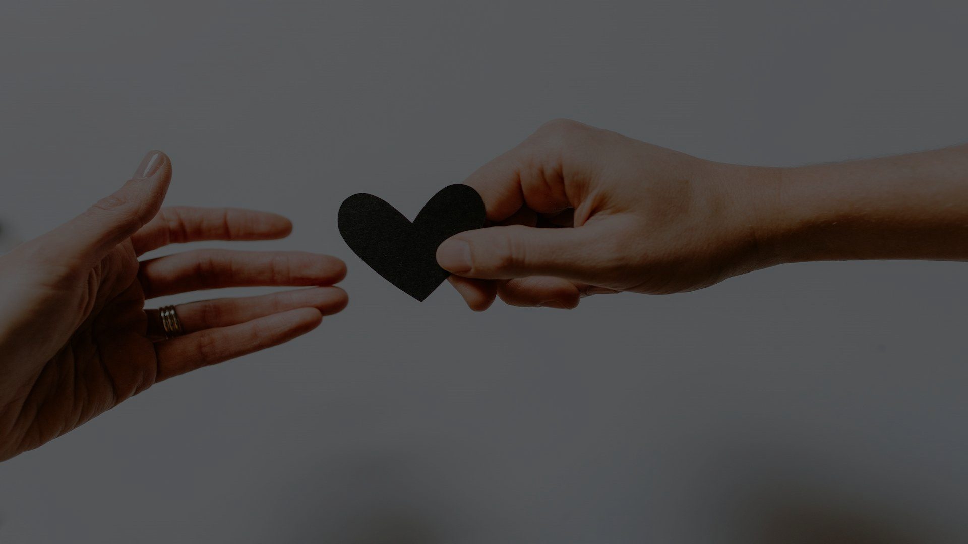 Two people's hands touching, passing a hand to each other